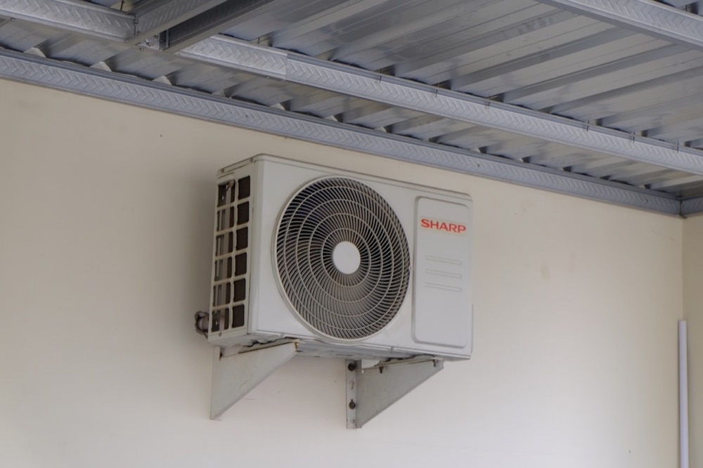 Central air conditioning condenser unit installed outside a Huron County home