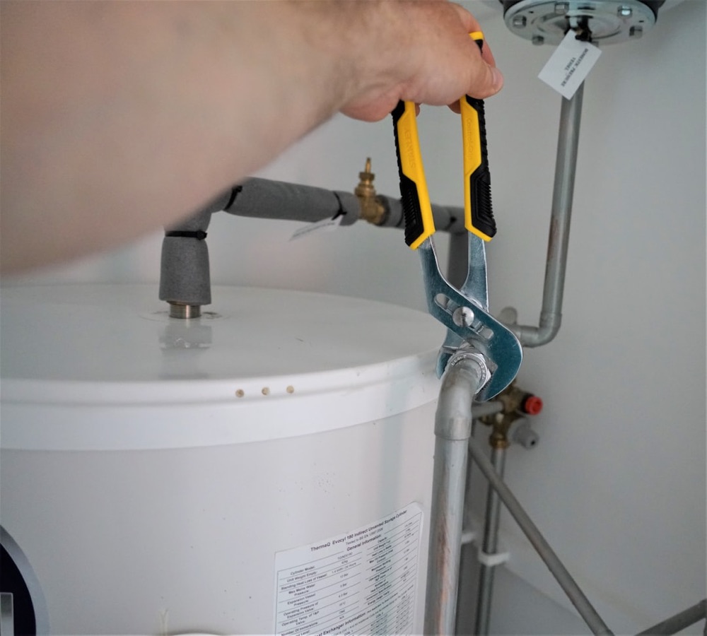 Tankless water heater mounted on a basement wall